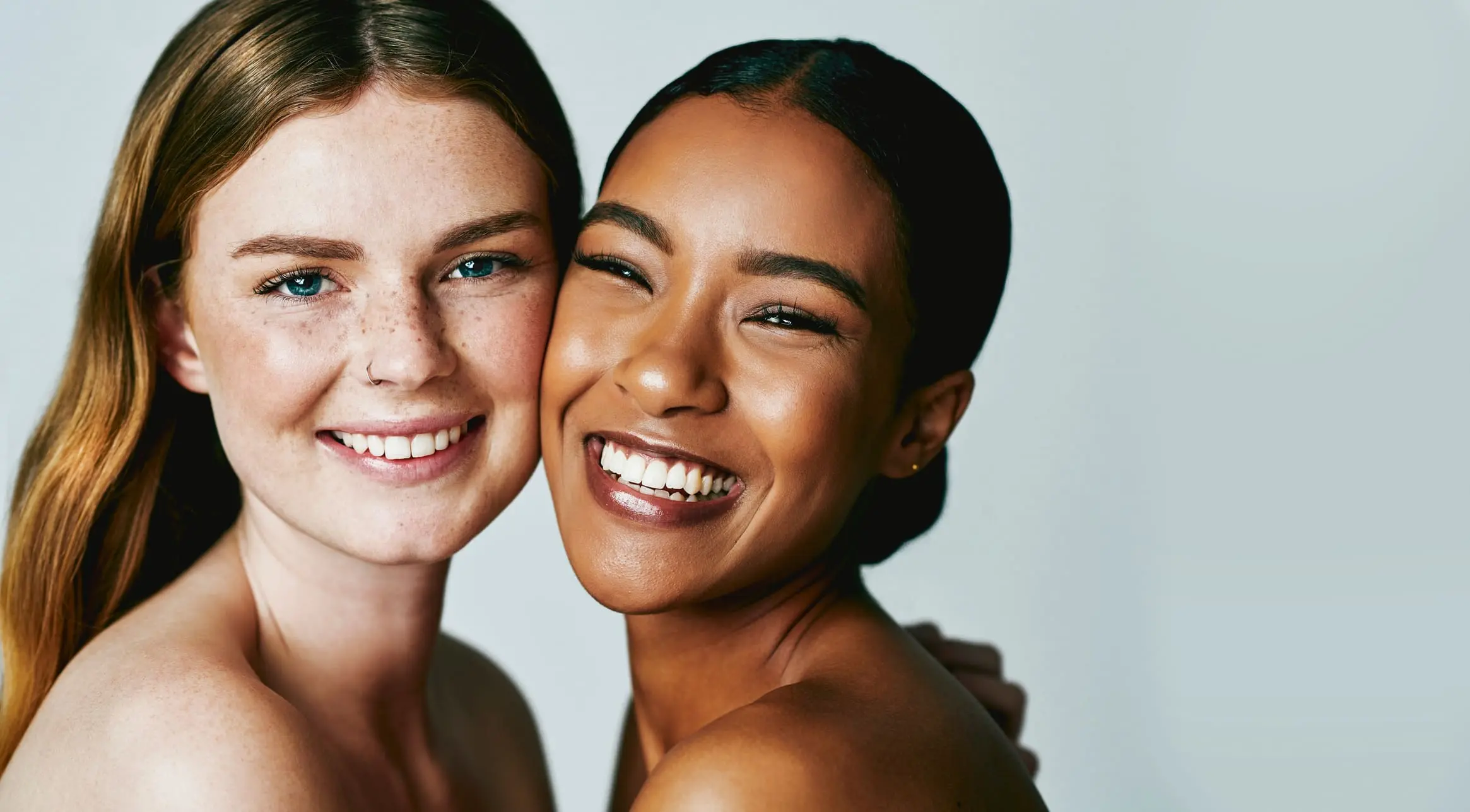 Studio shot of two attractive young women posing against grey background Sculptra in Charleston County, SC